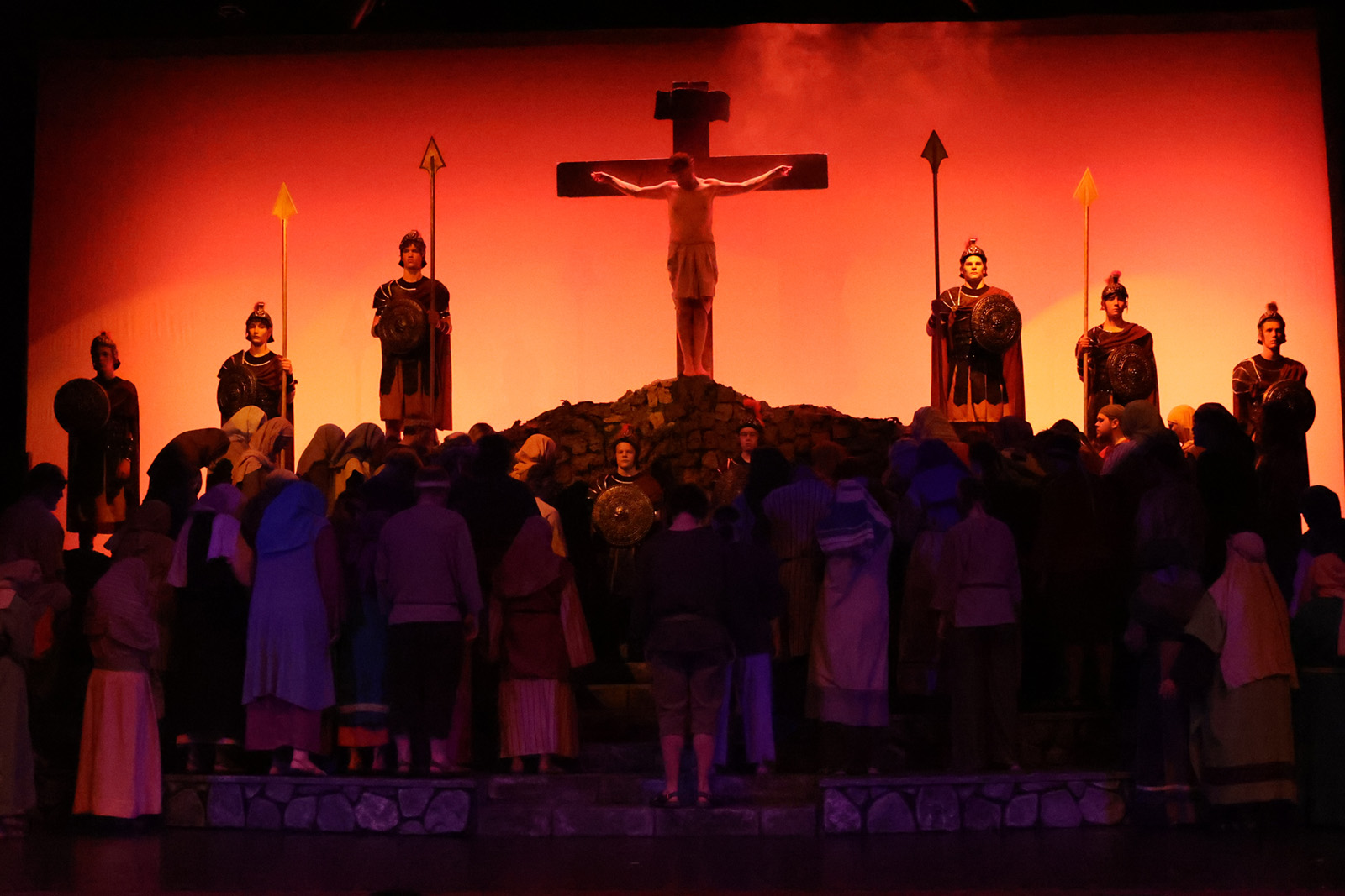 Jesus is on the cross, surrounded by onlookers.